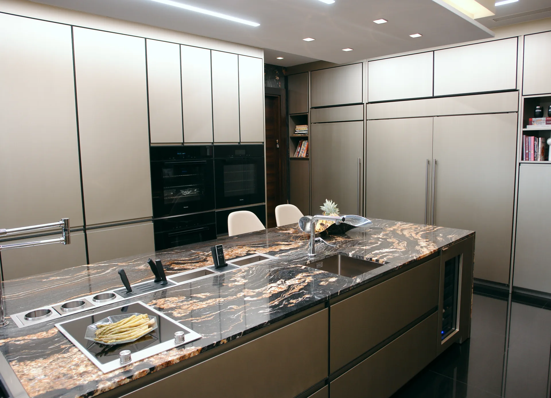 Cocina con isla en granito veteado y frentes lacados